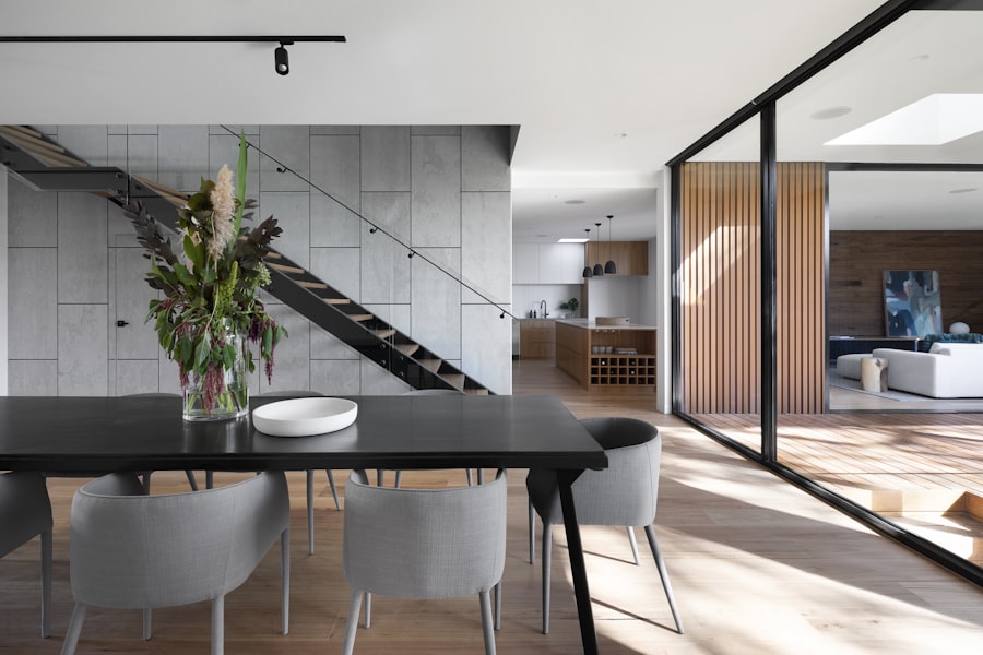 A sweeping bespoke timber staircase with smooth oak handrail in a bright modern home